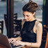 Woman working on a laptop computer.