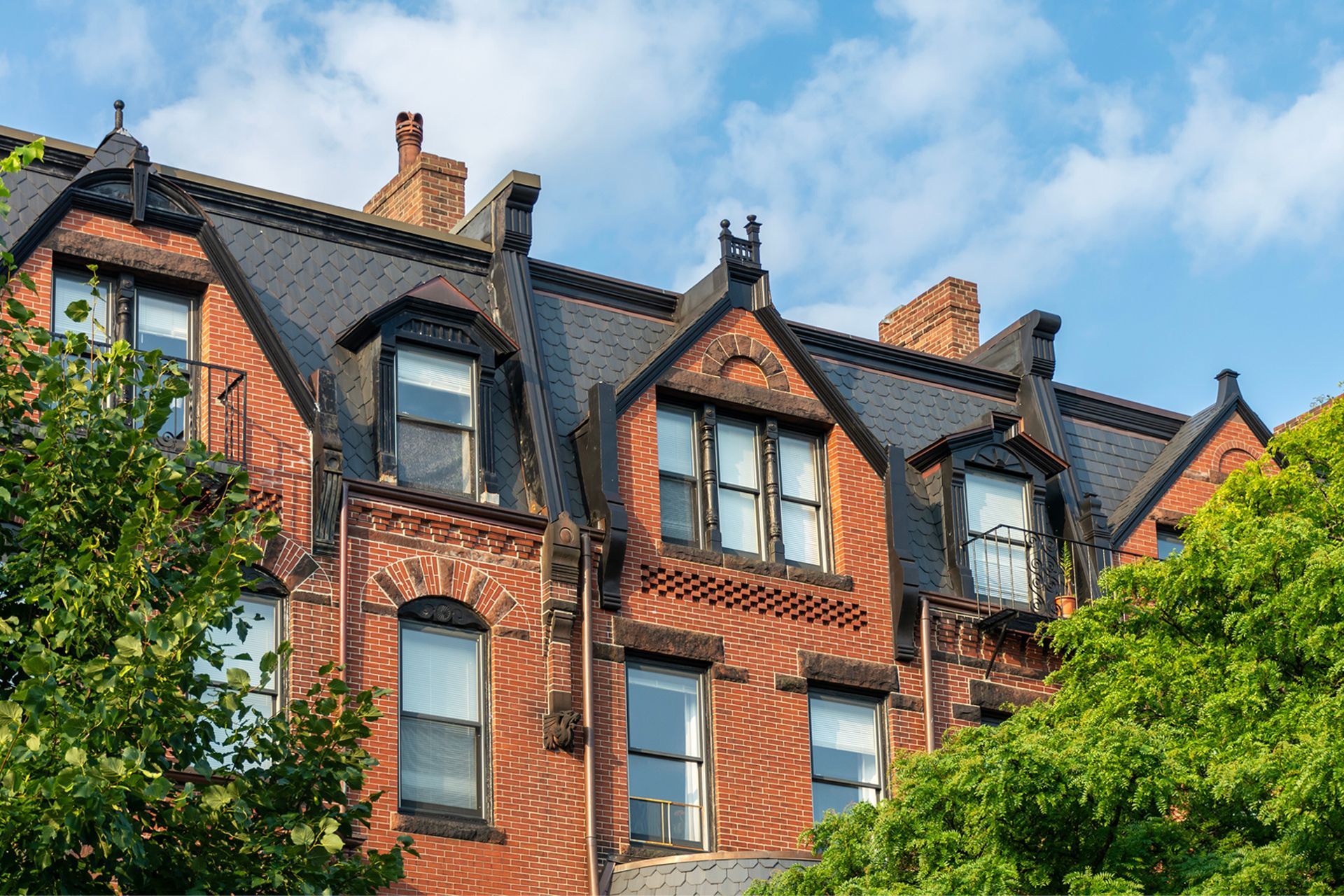 Victorian apartment building with brick chimneys.
