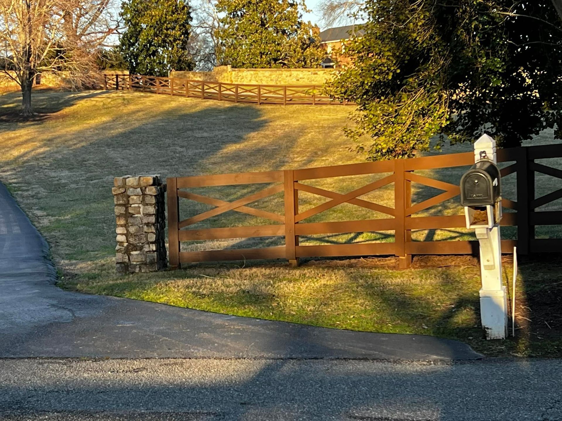 A wooden fence with a mailbox in front of it