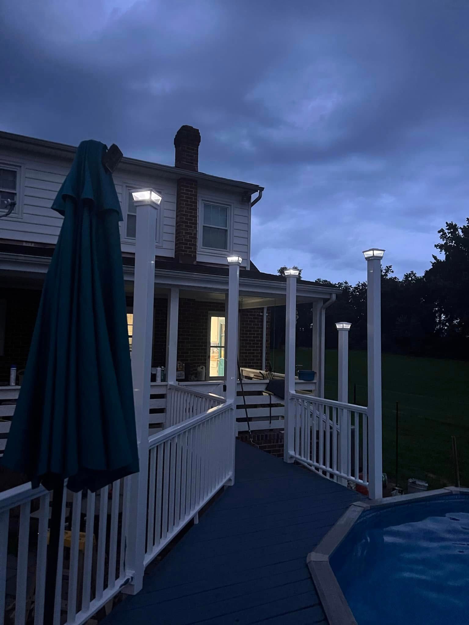 A large white house with a swimming pool in front of it.