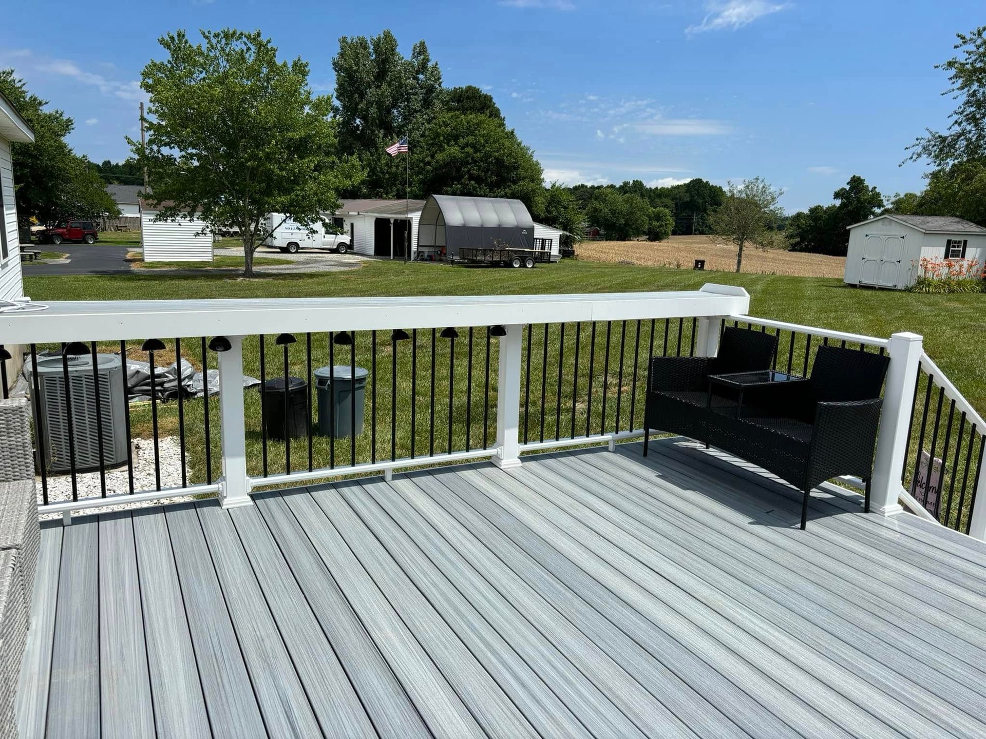 A deck with a couch and chairs on it