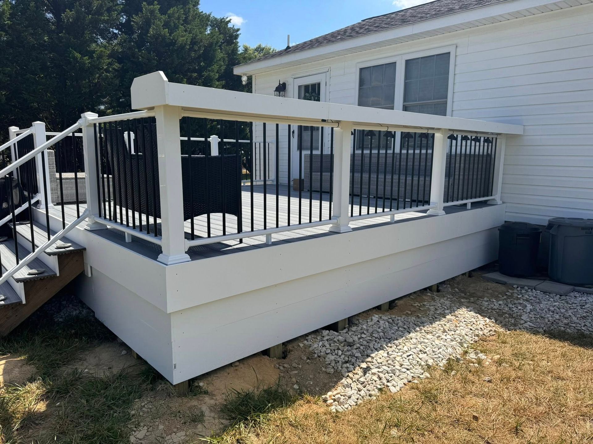A deck with a couch and chairs on it