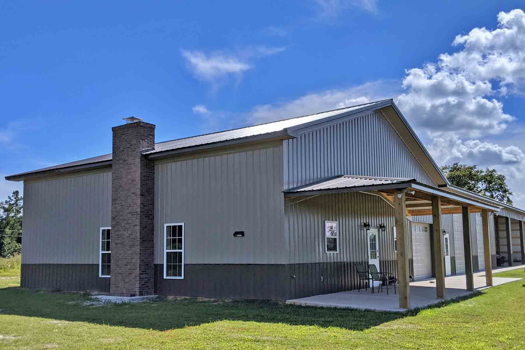 Spacious green lawn bordered by a new wooden fence, adorned with sturdy stone brick pillars.