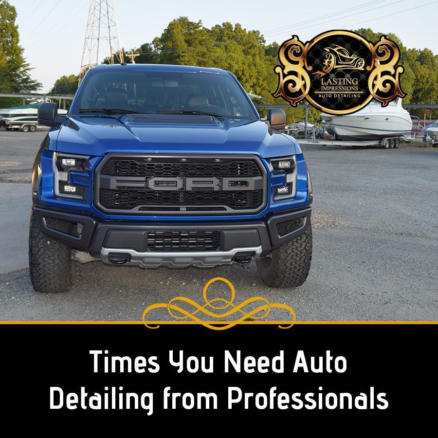 A blue ford raptor is parked in a parking lot