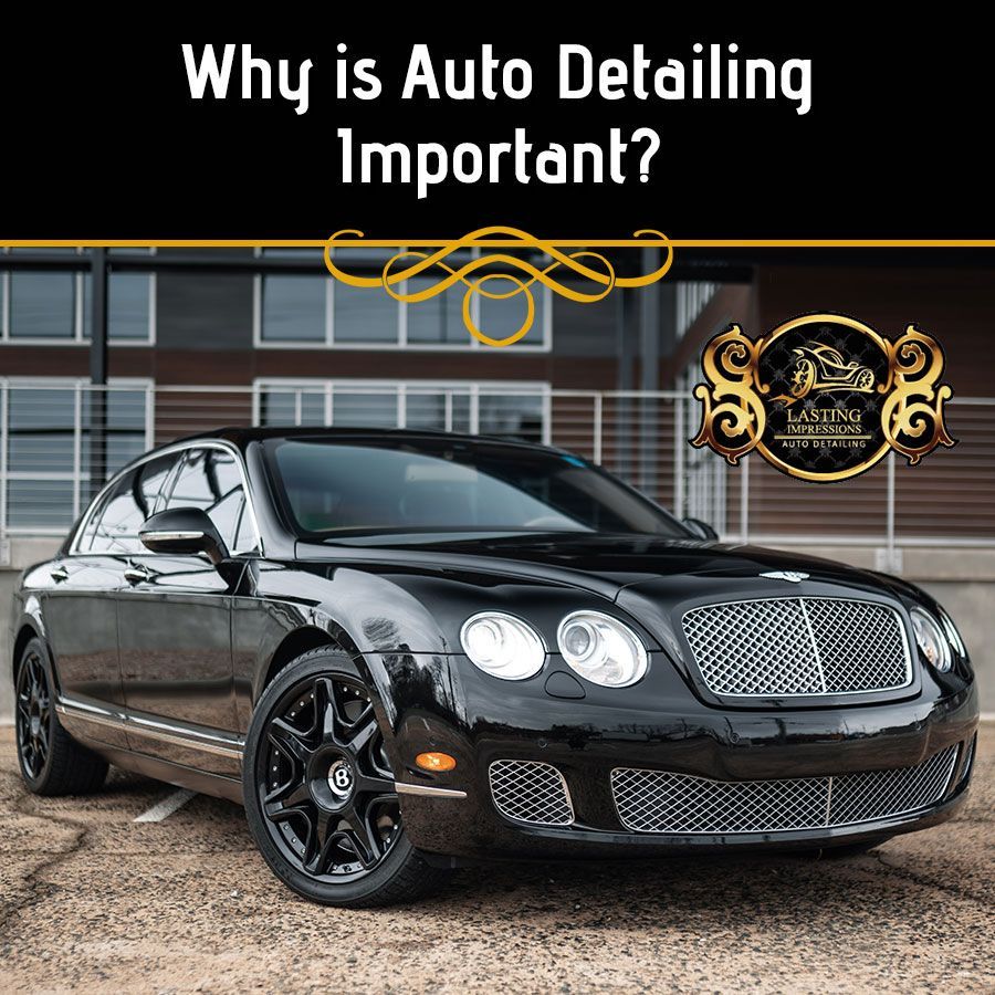 A black bentley is parked in front of a building.