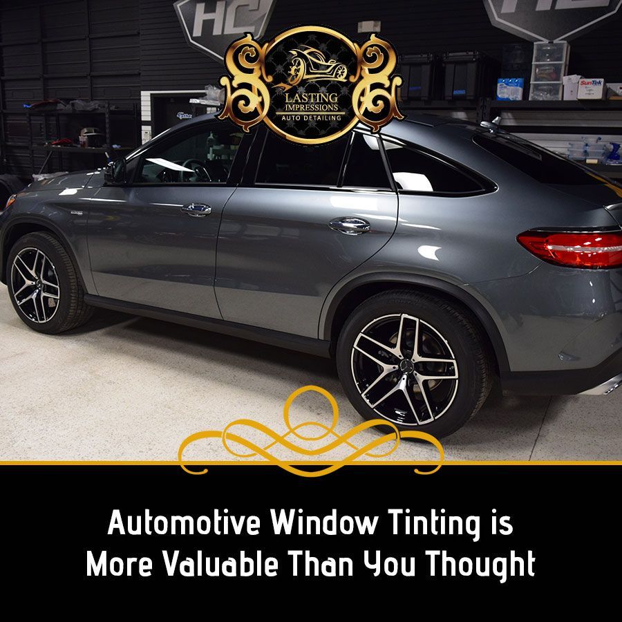 A gray car with the words automotive window tinting is more valuable than you thought