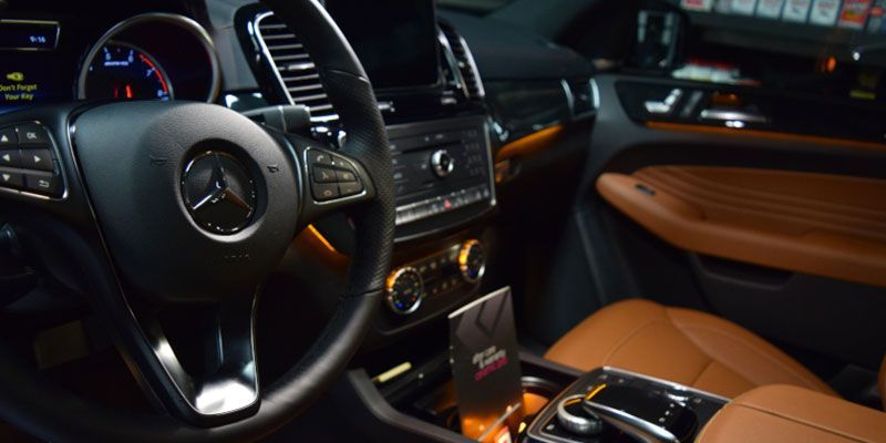 A close up of the steering wheel and dashboard of a car.