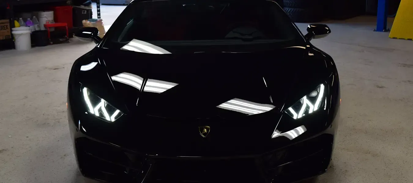 A person wearing black gloves is touching a tire