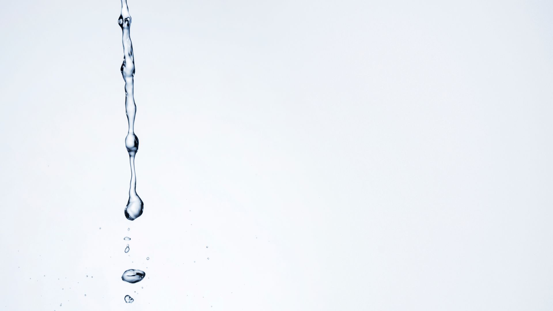 A Stream of Water Falling Against a White Background — Hot Water Specialist Forster In Forster, NSW