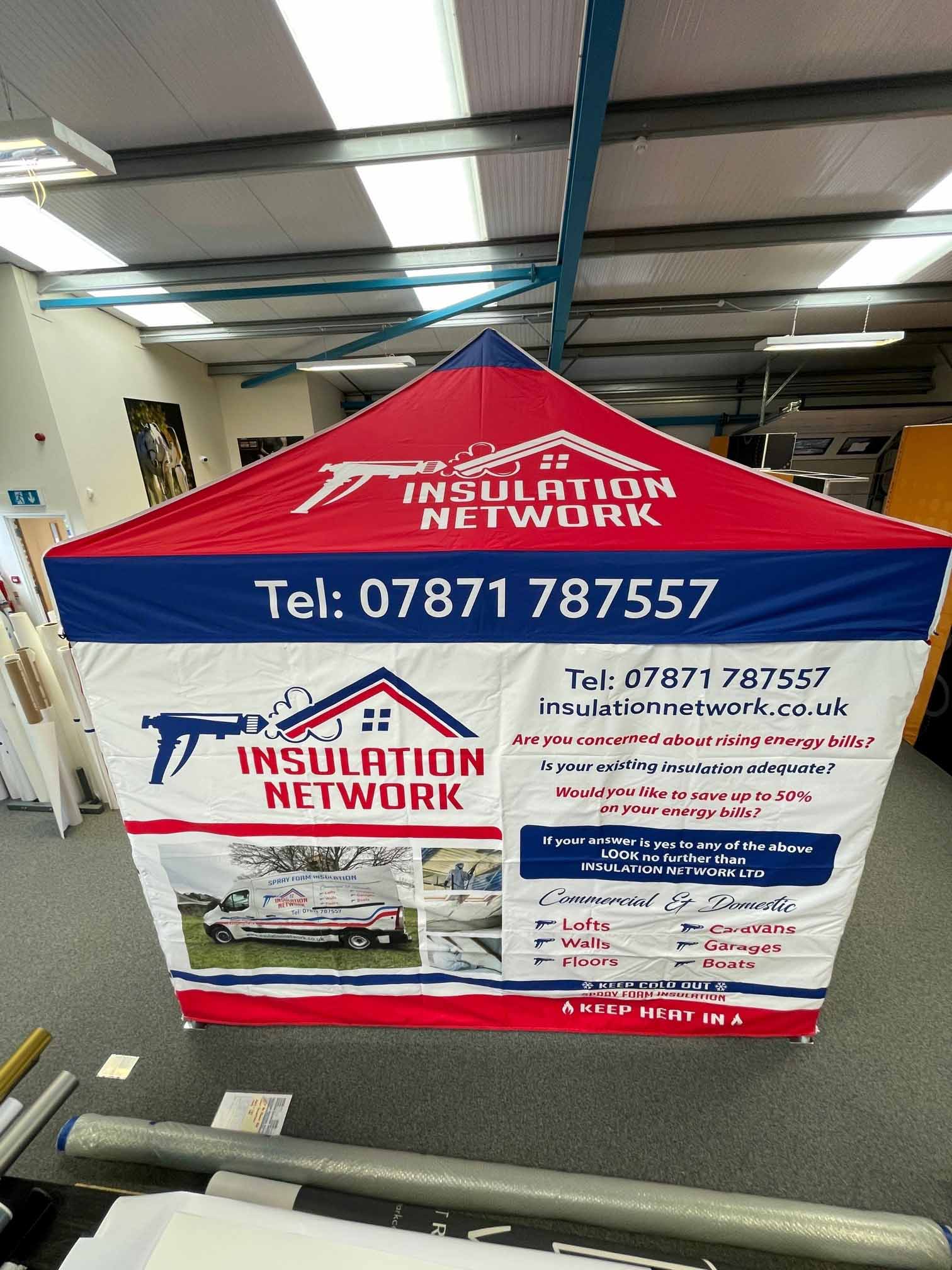 An insulation network tent is sitting on the floor in a room.