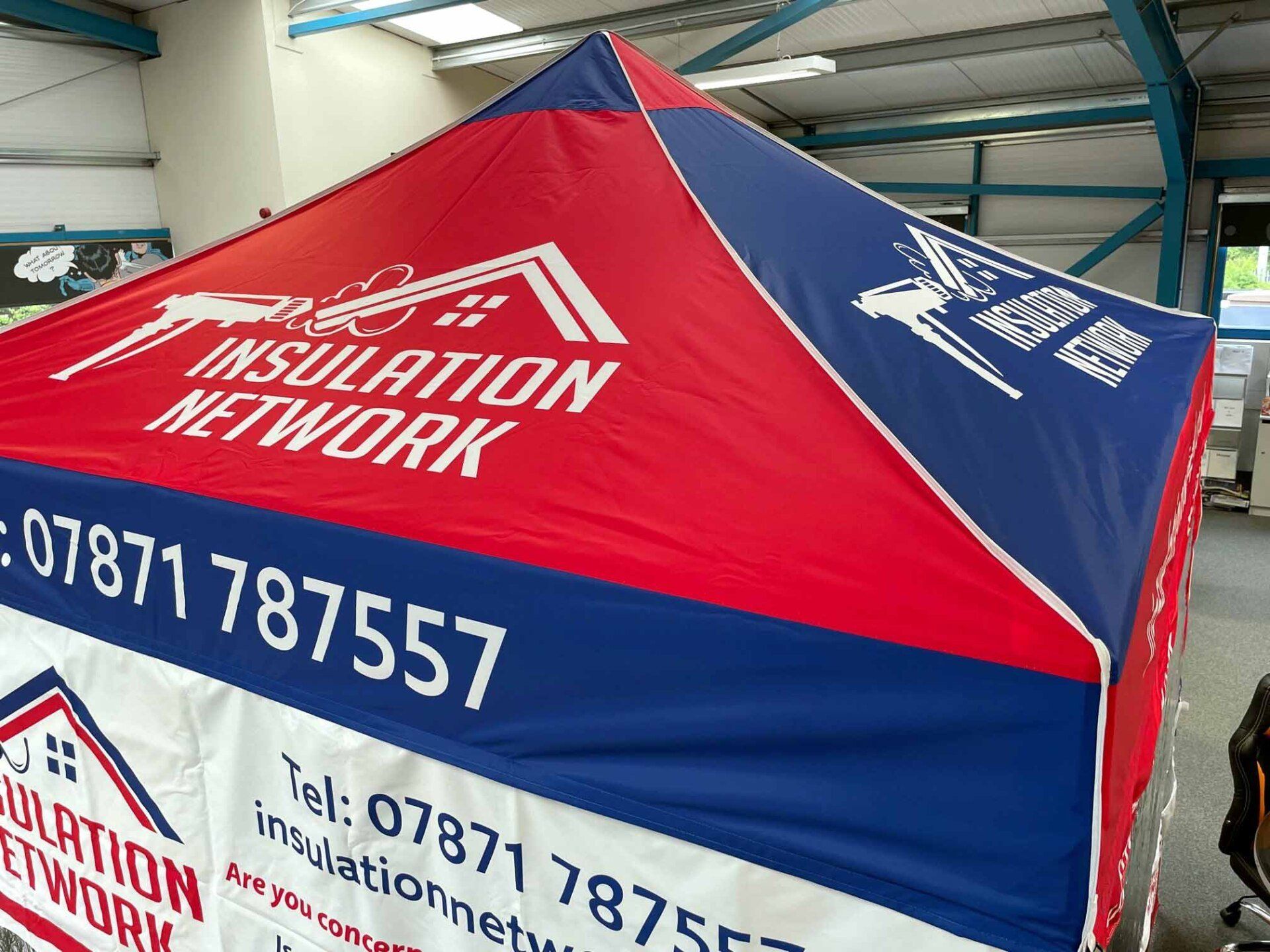 A red and blue tent with the words insulation network on it