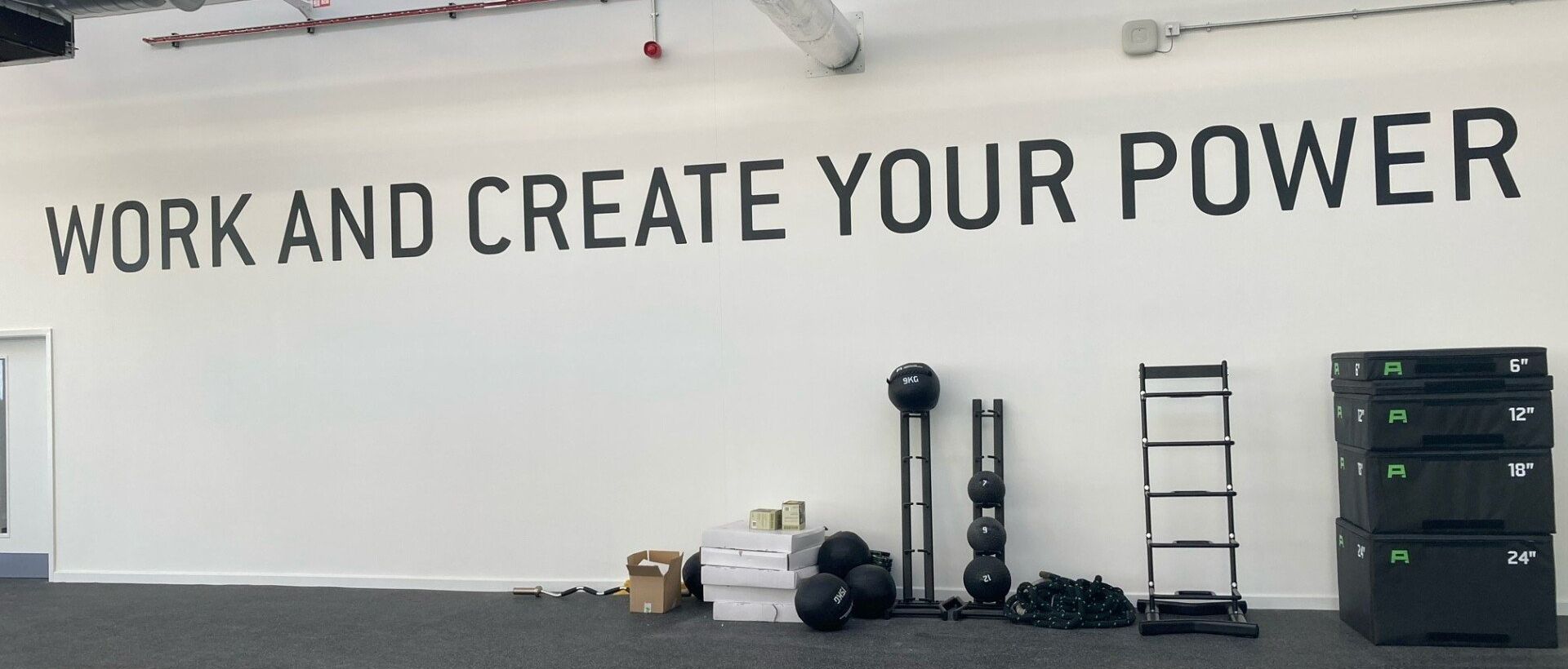 A sign on a wall that says work and create your power