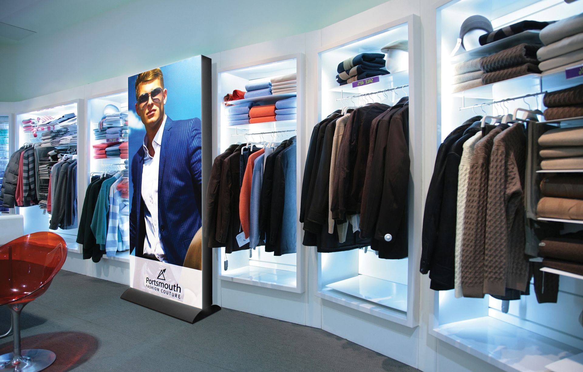 A clothing store with a large picture of a man on the wall.