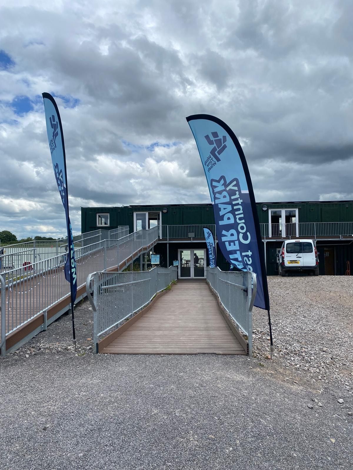 N3 Display Graphics | A building with a ramp and flags in front of it.