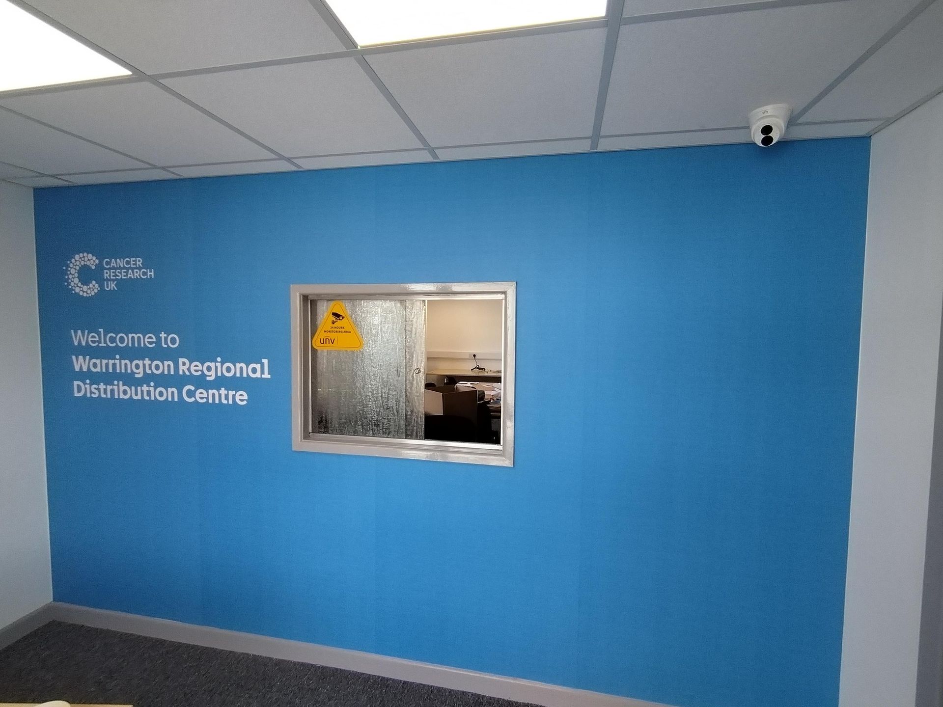 A blue wall with welcome to washington regional distribution centre written on it
