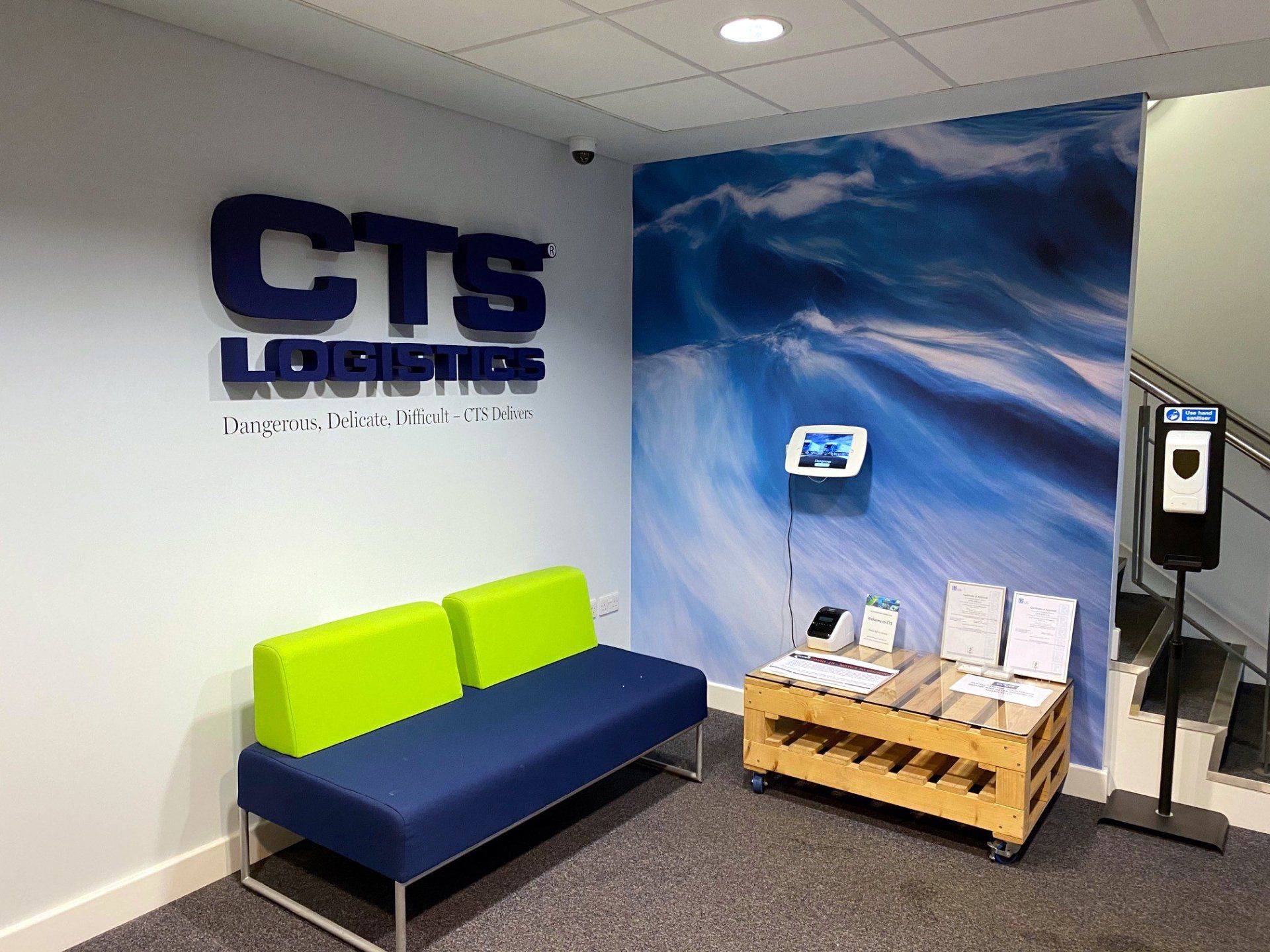 A waiting room with a couch and a sign that says cts logistics.