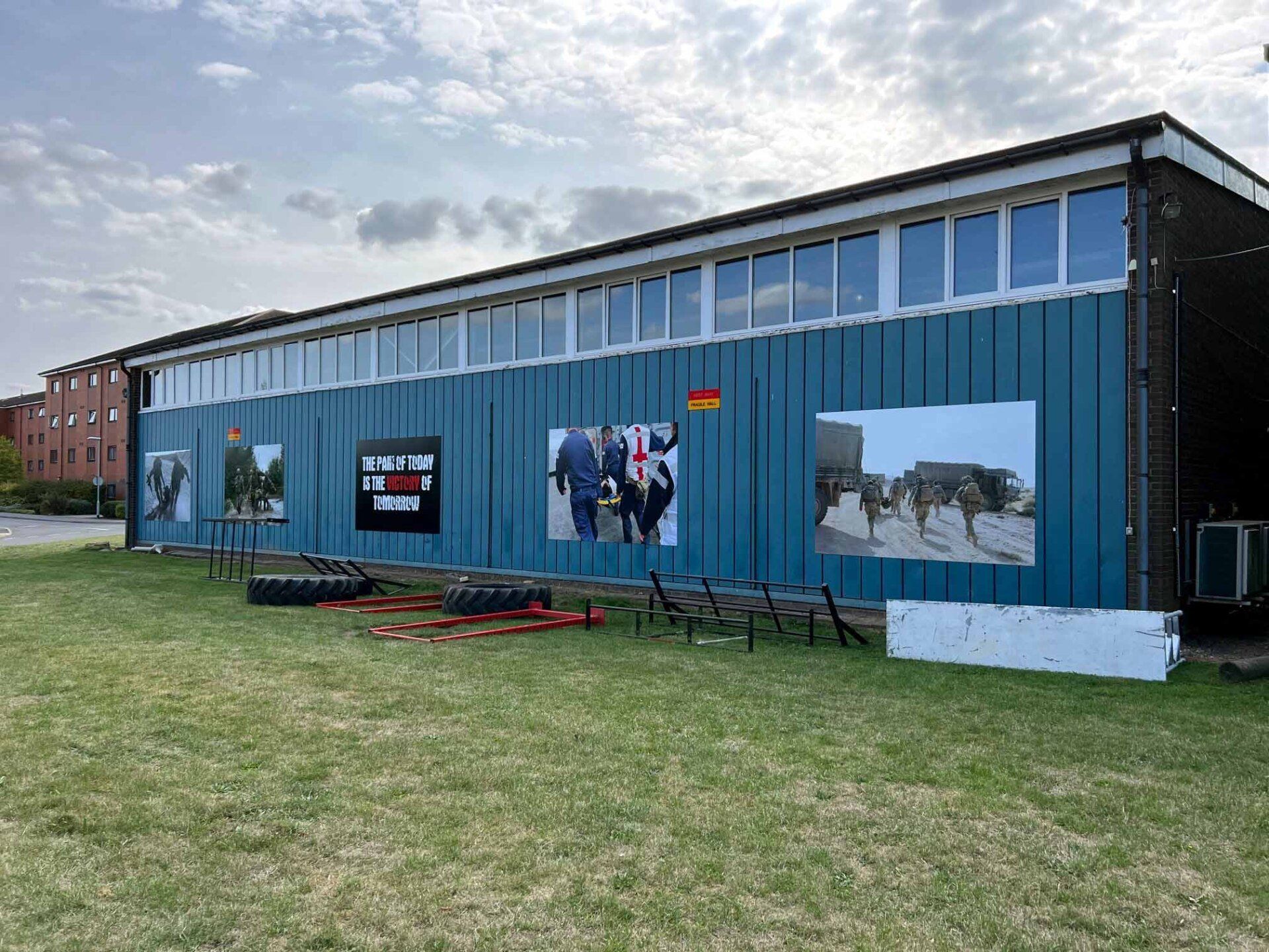 A large blue building with a lot of windows and pictures on the side of it.