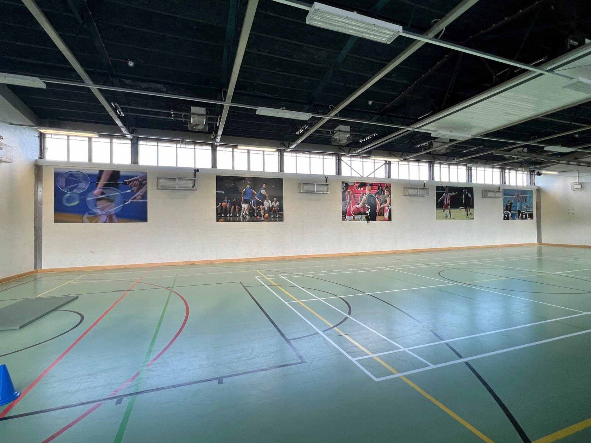 A basketball court with a lot of pictures on the wall