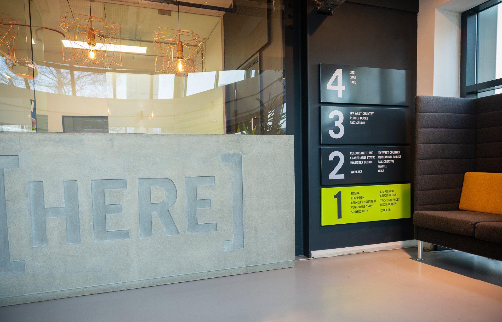 A concrete wall with the word here written on it