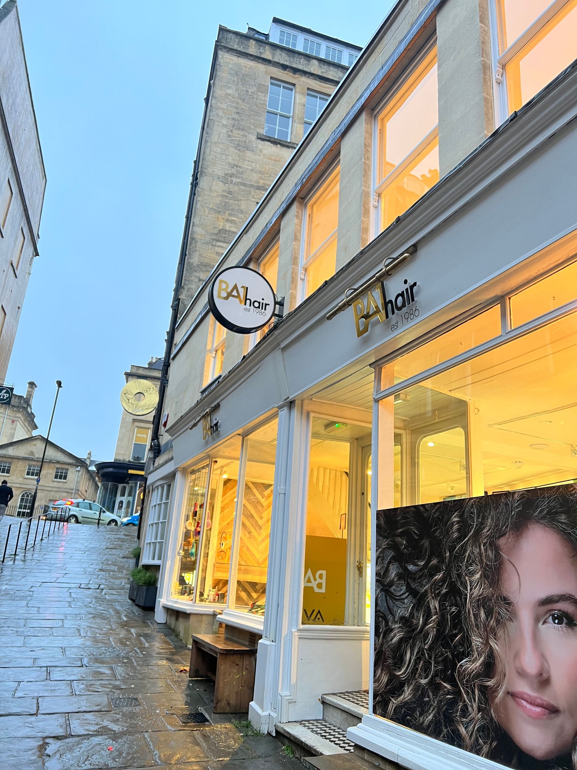 A store front with a picture of a woman in the window.