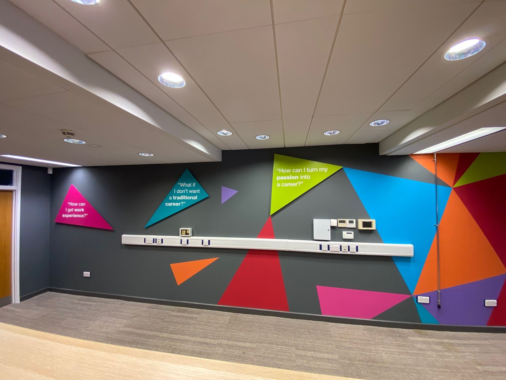 A room with colorful geometric shapes painted on the wall