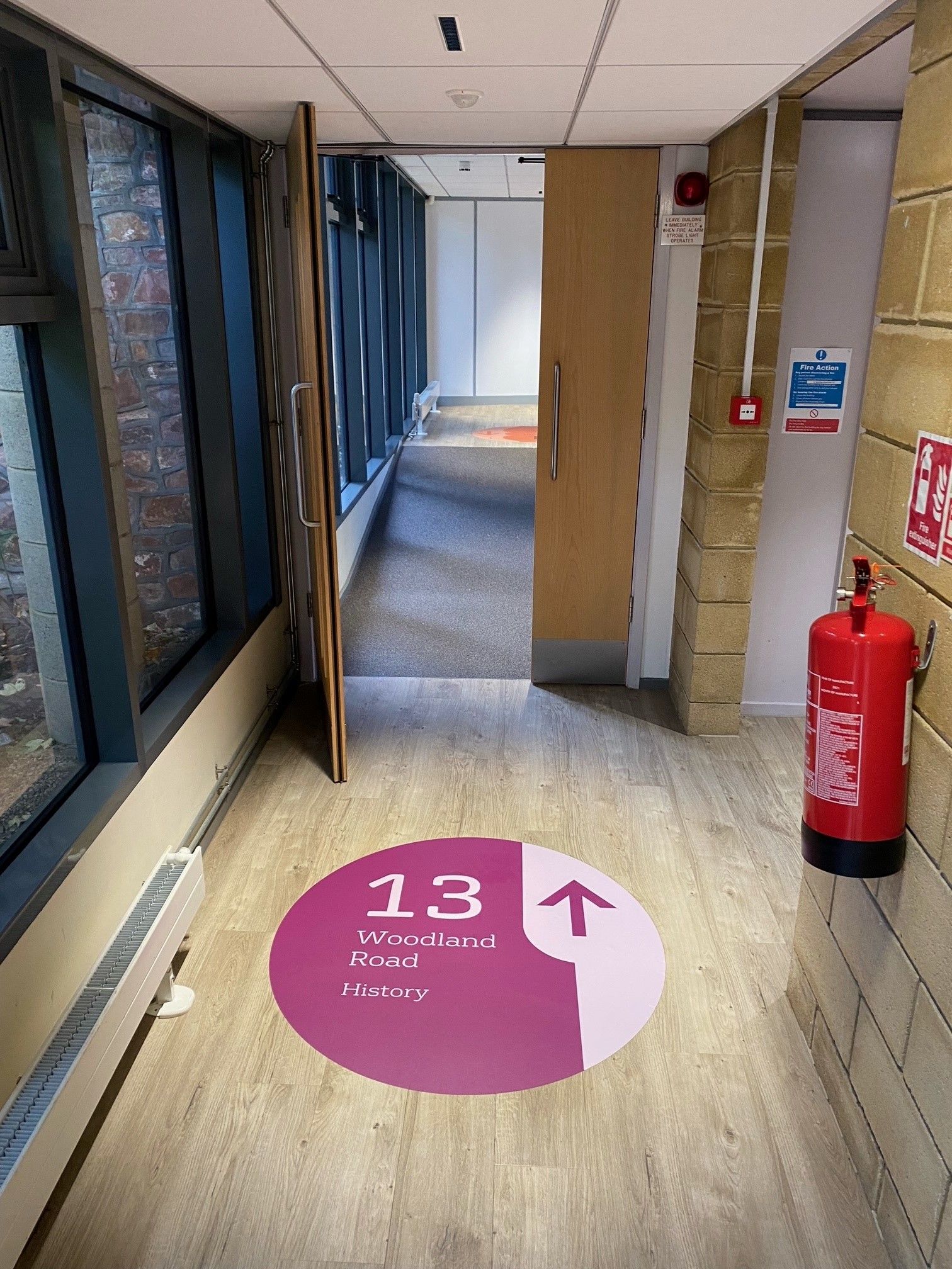 A hallway with a sign on the floor that says 13