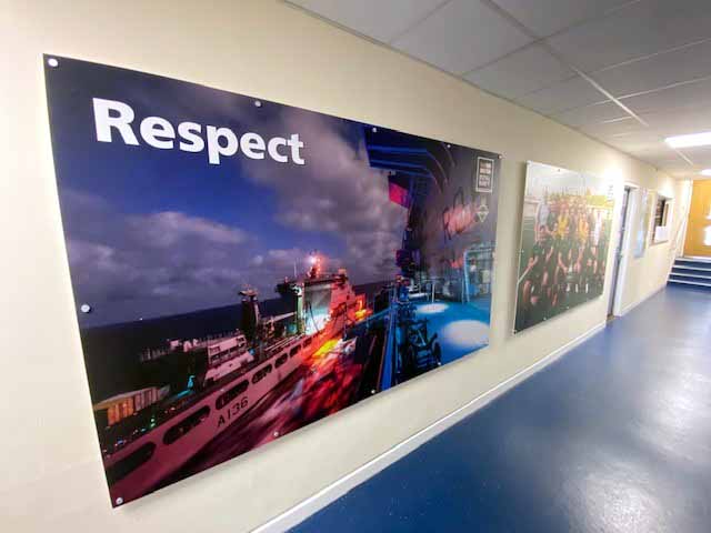 A hallway with a painting on the wall that says respect
