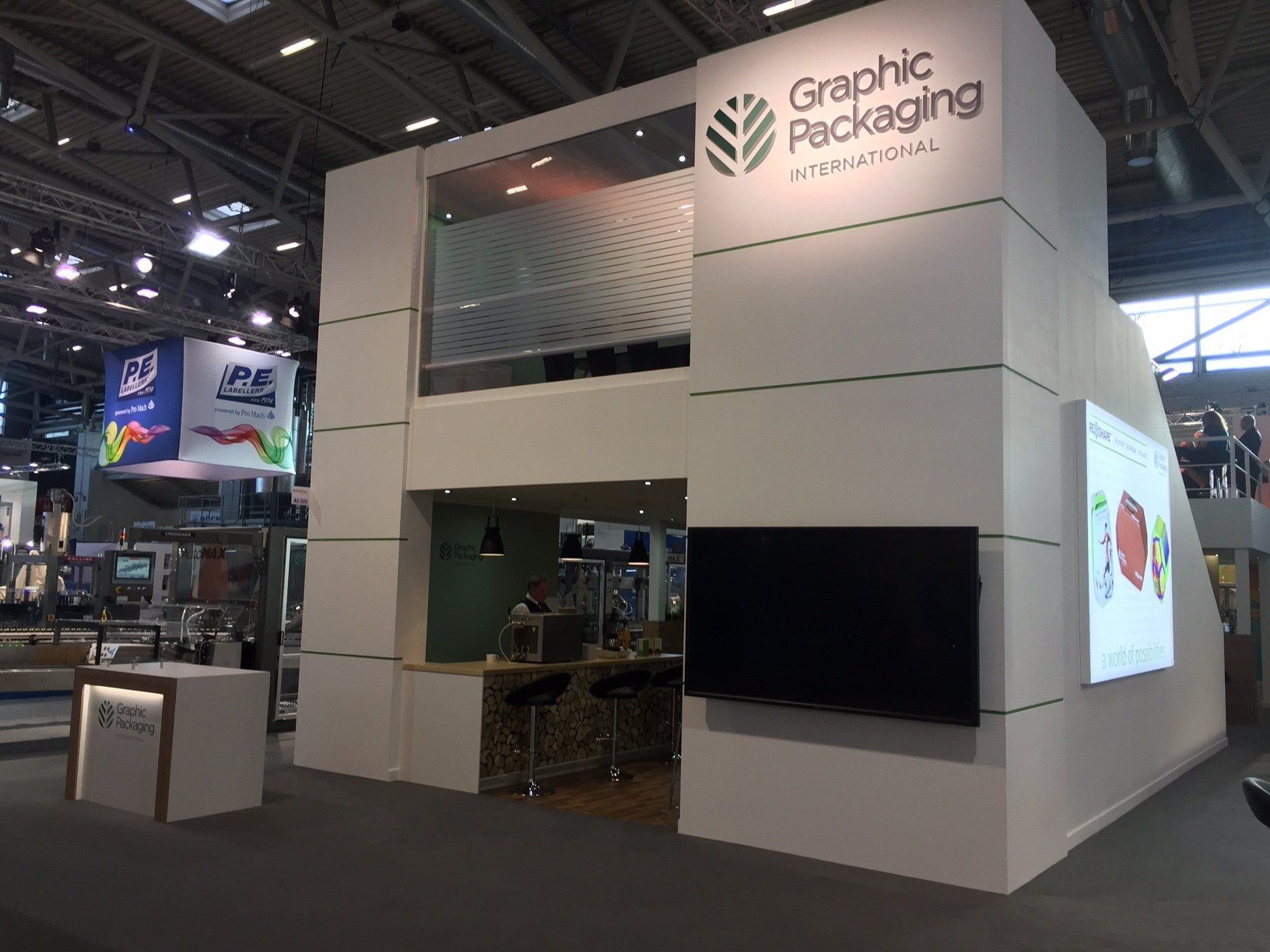 A graphic packaging booth with a tv on the wall