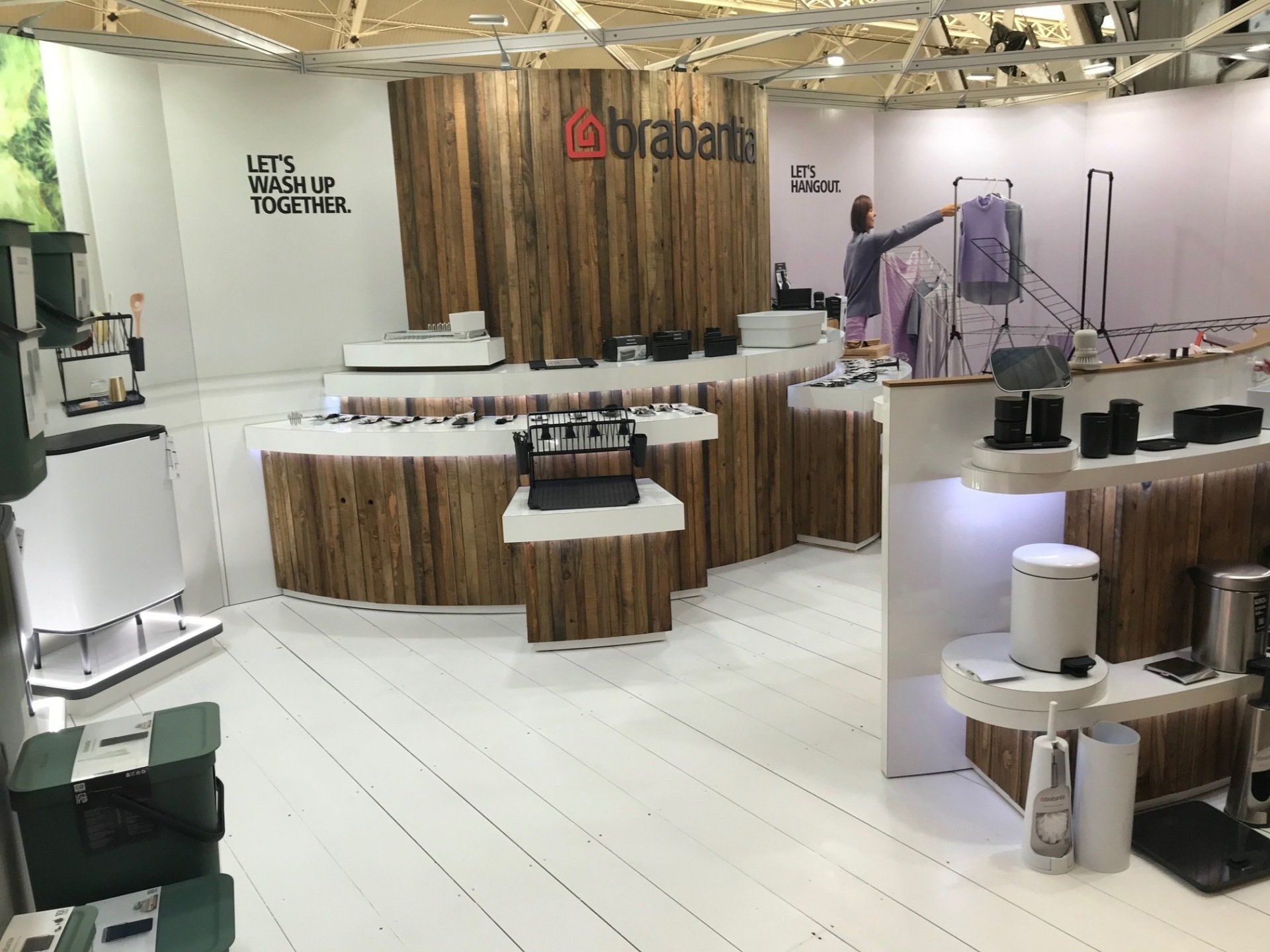 A man is standing in a room with a sign that says brabantia on it.