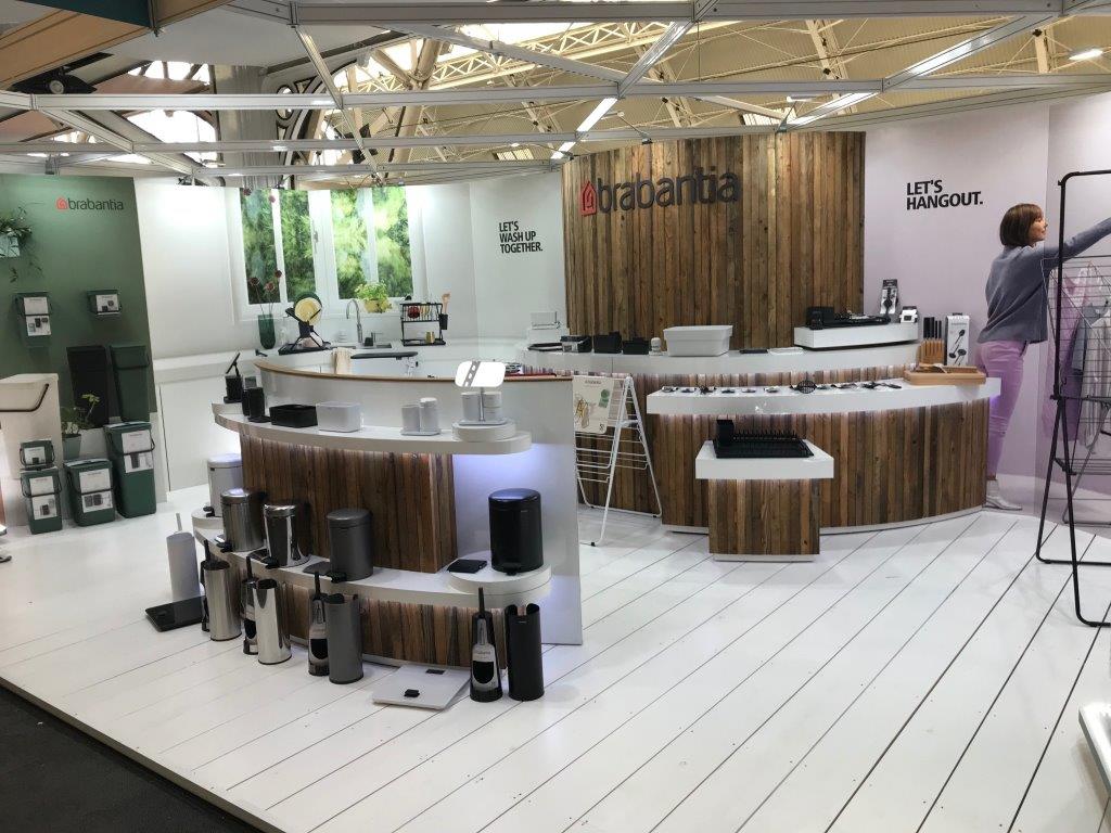 A woman is standing in front of a counter in a store.