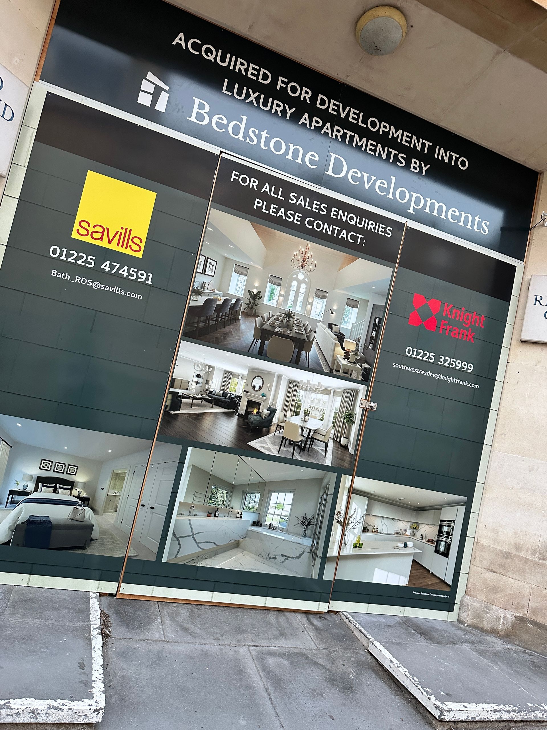 A large advertisement for bedstone development is hanging on a wall