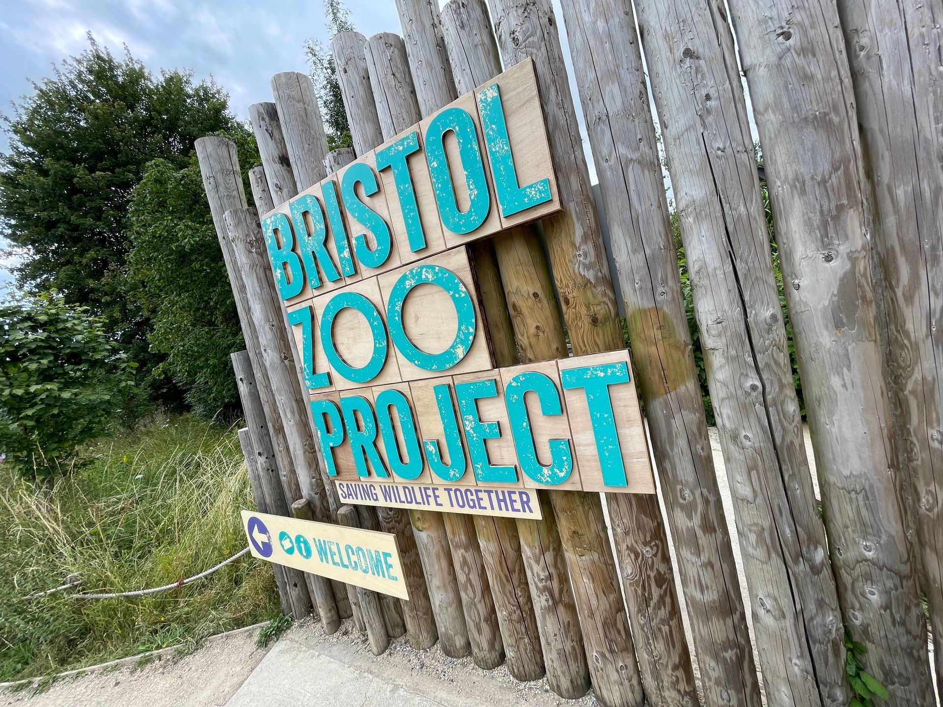 A wooden fence with a sign that says bristol zoo project on it.