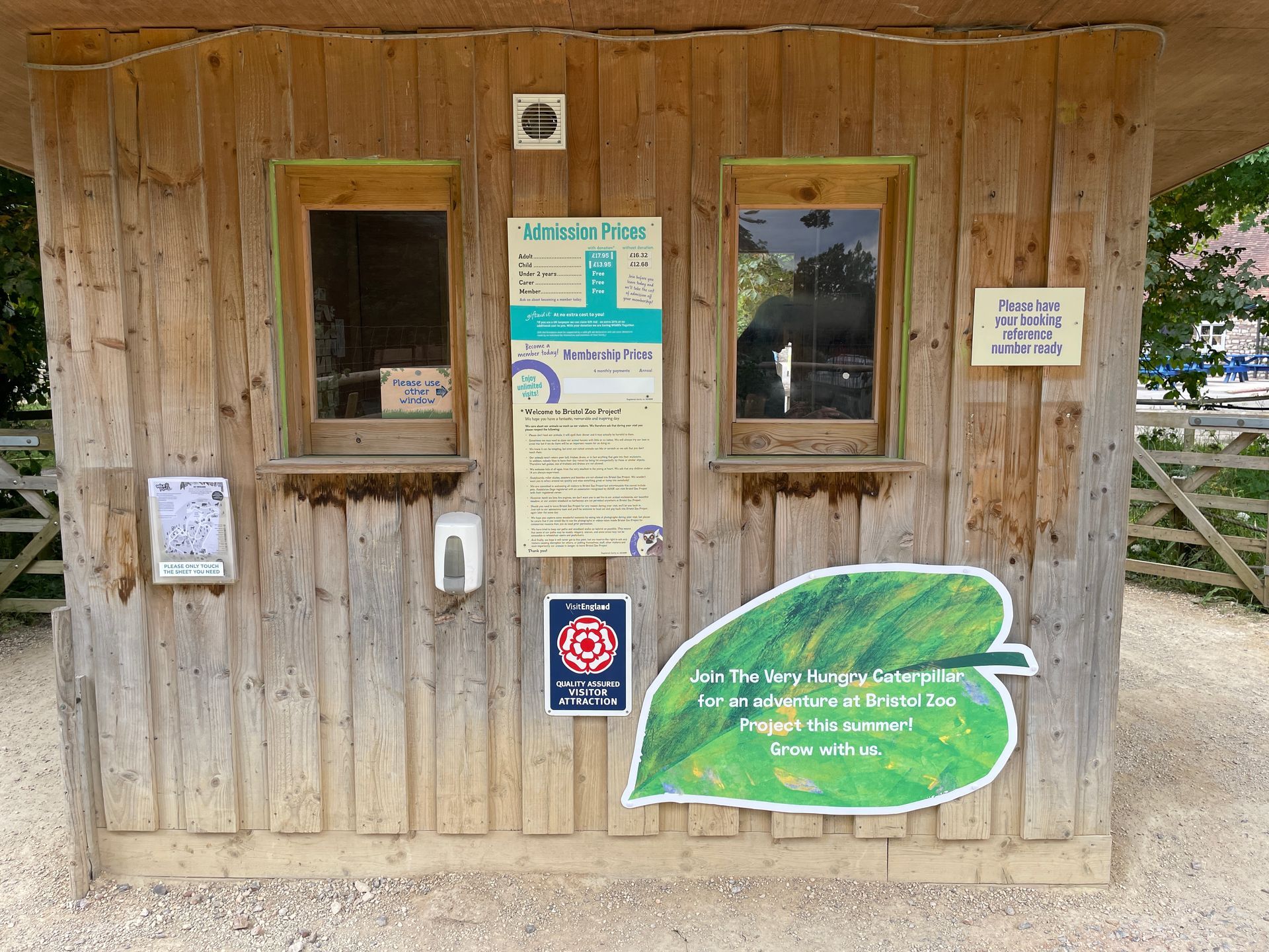 A wooden building with a green leaf on the side