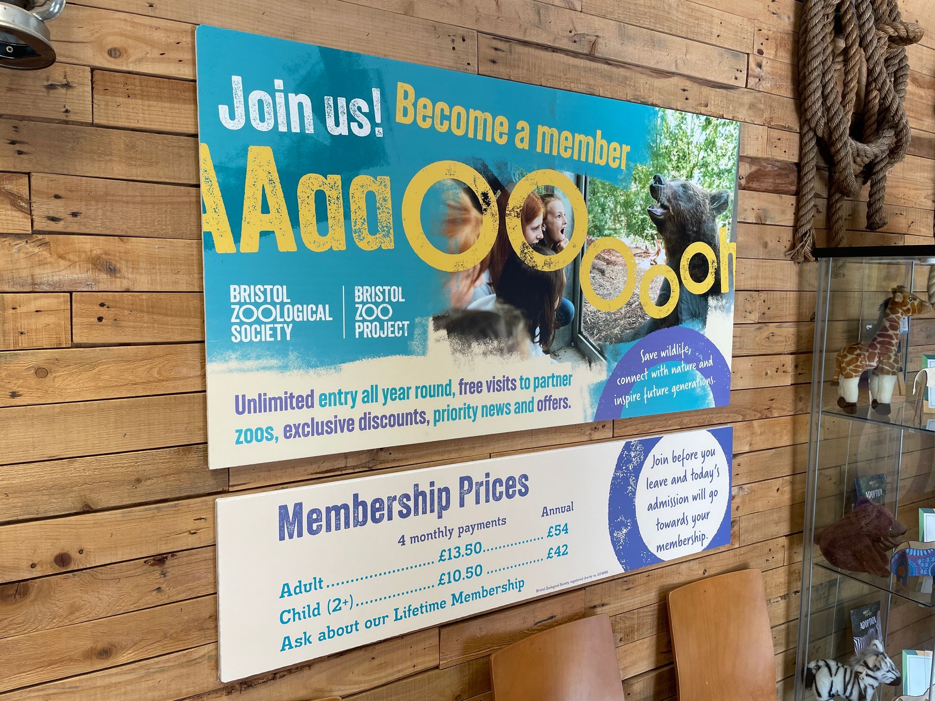 A sign on a wooden wall that says join us become a member