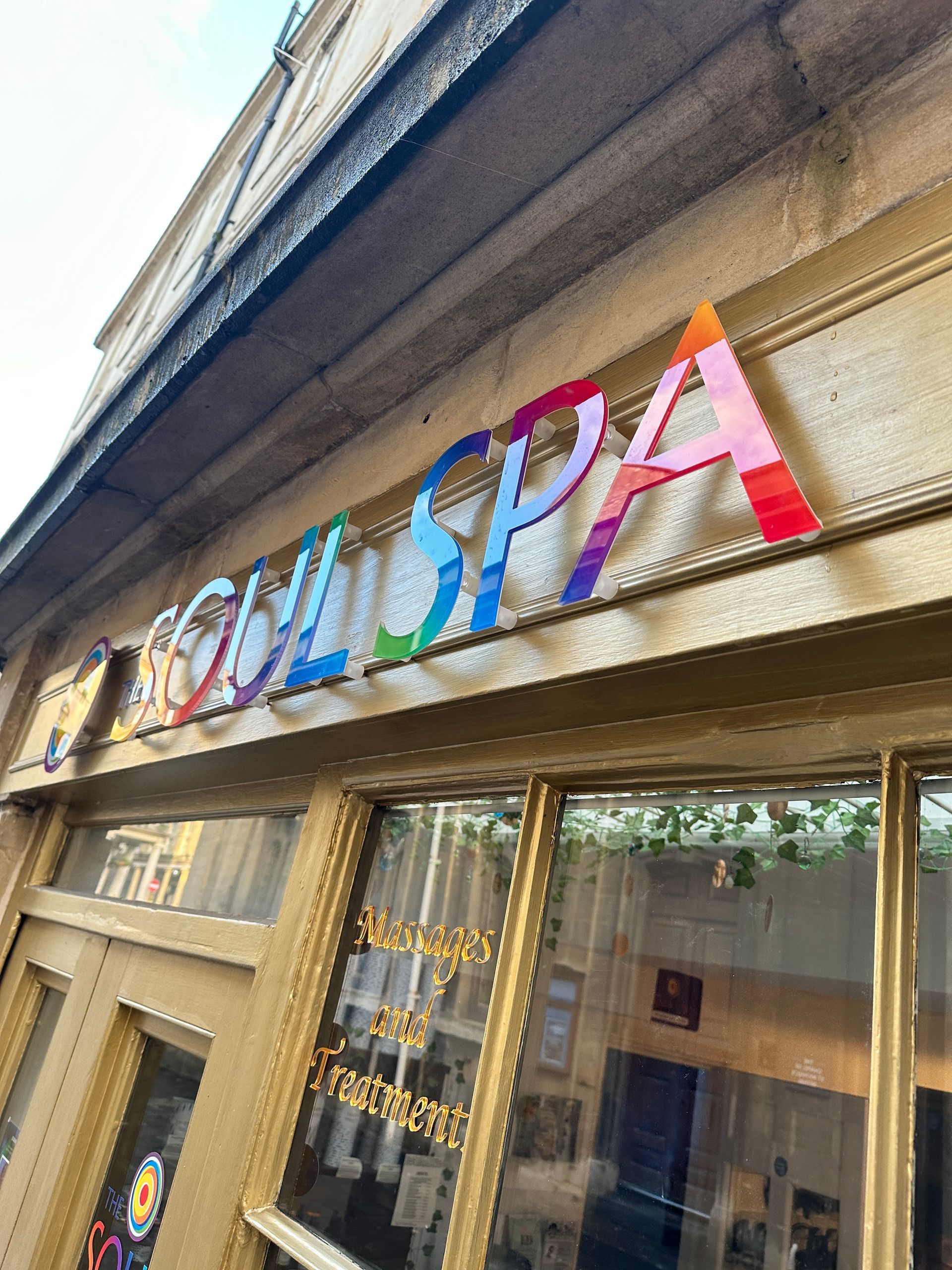 A colorful sign on the side of a building says soul spa.