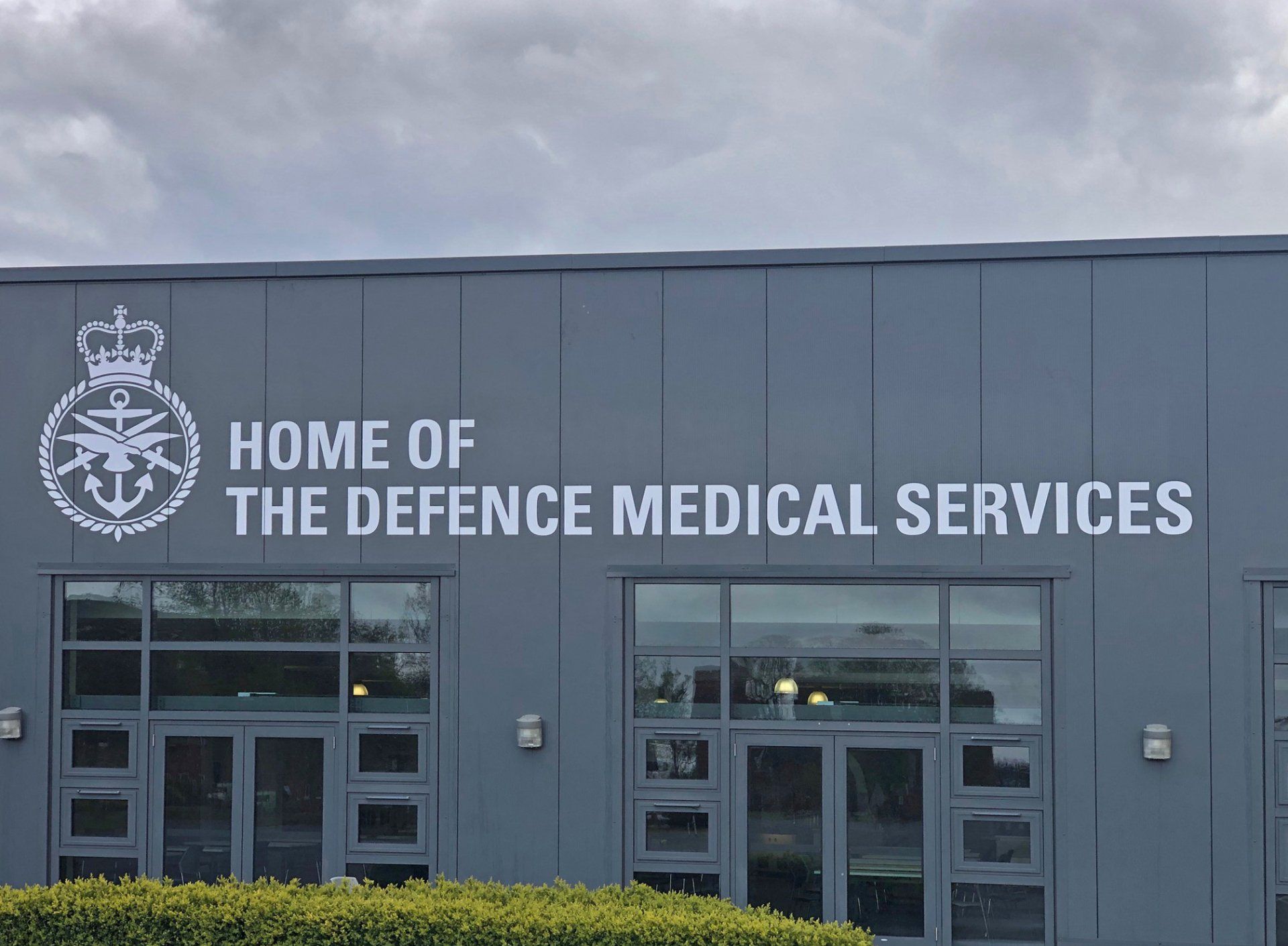 A building with a sign that says home of the defence medical services