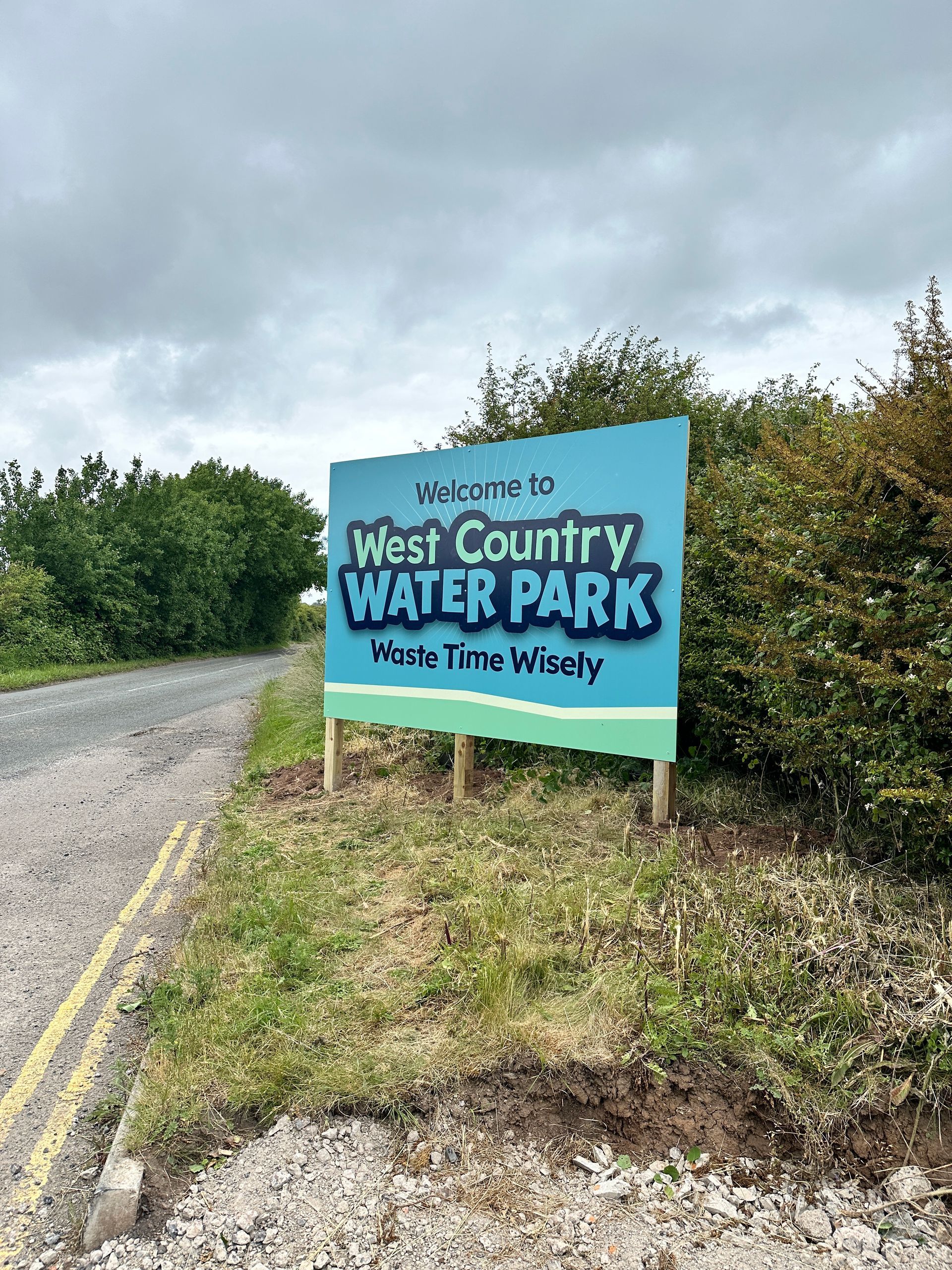 N3 Display Graphics | A sign for west country water park is sitting on the side of a road.