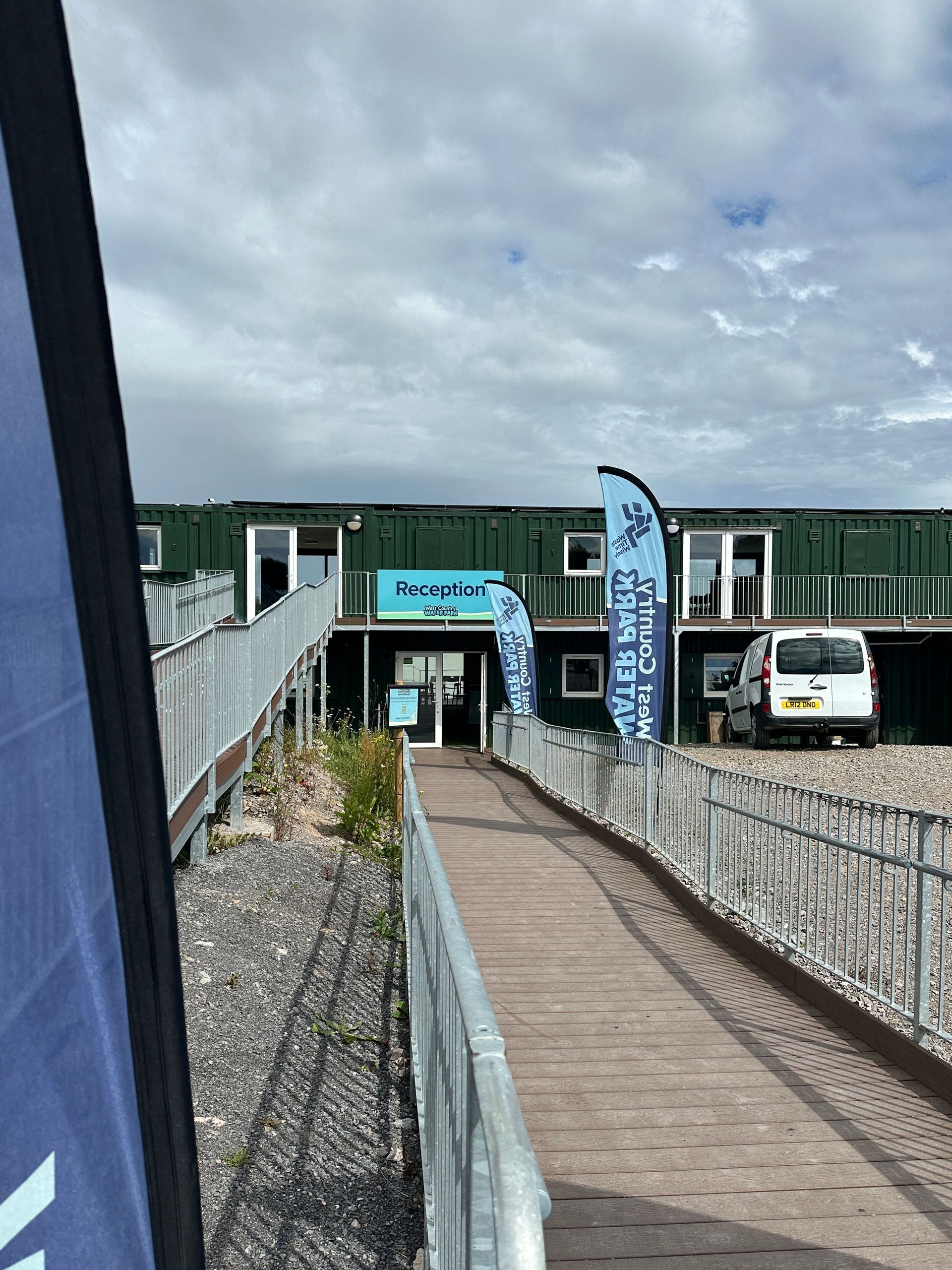 N3 Display Graphics | A walkway leading to a building with flags on the side of it.