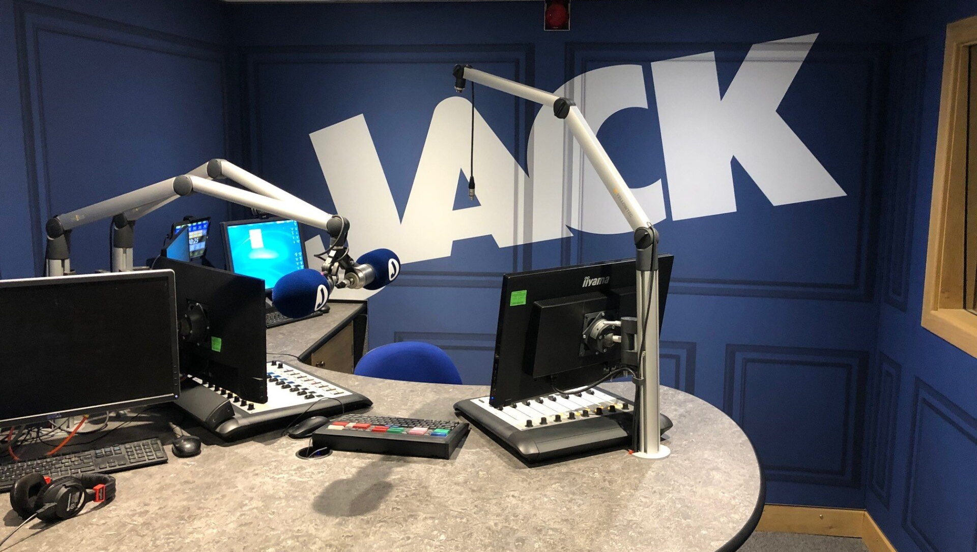 A radio studio with the word jack painted on the wall