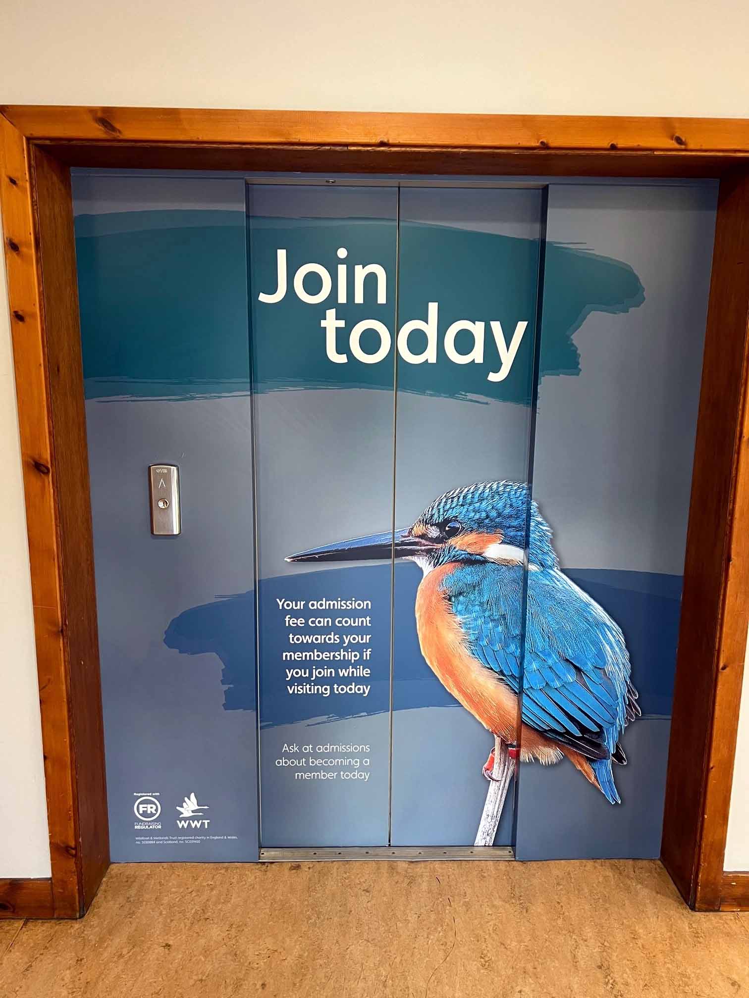 An elevator with a picture of a bird and the words `` join today '' on it.