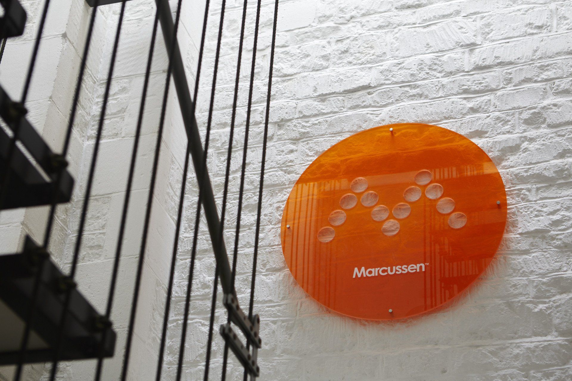 A staircase with a sign on the wall that says marcussen