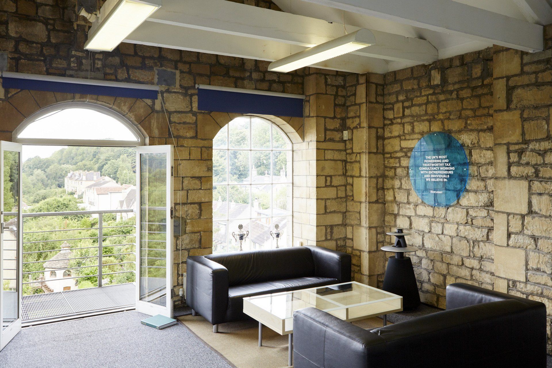 A living room with a brick wall and a couch and a table