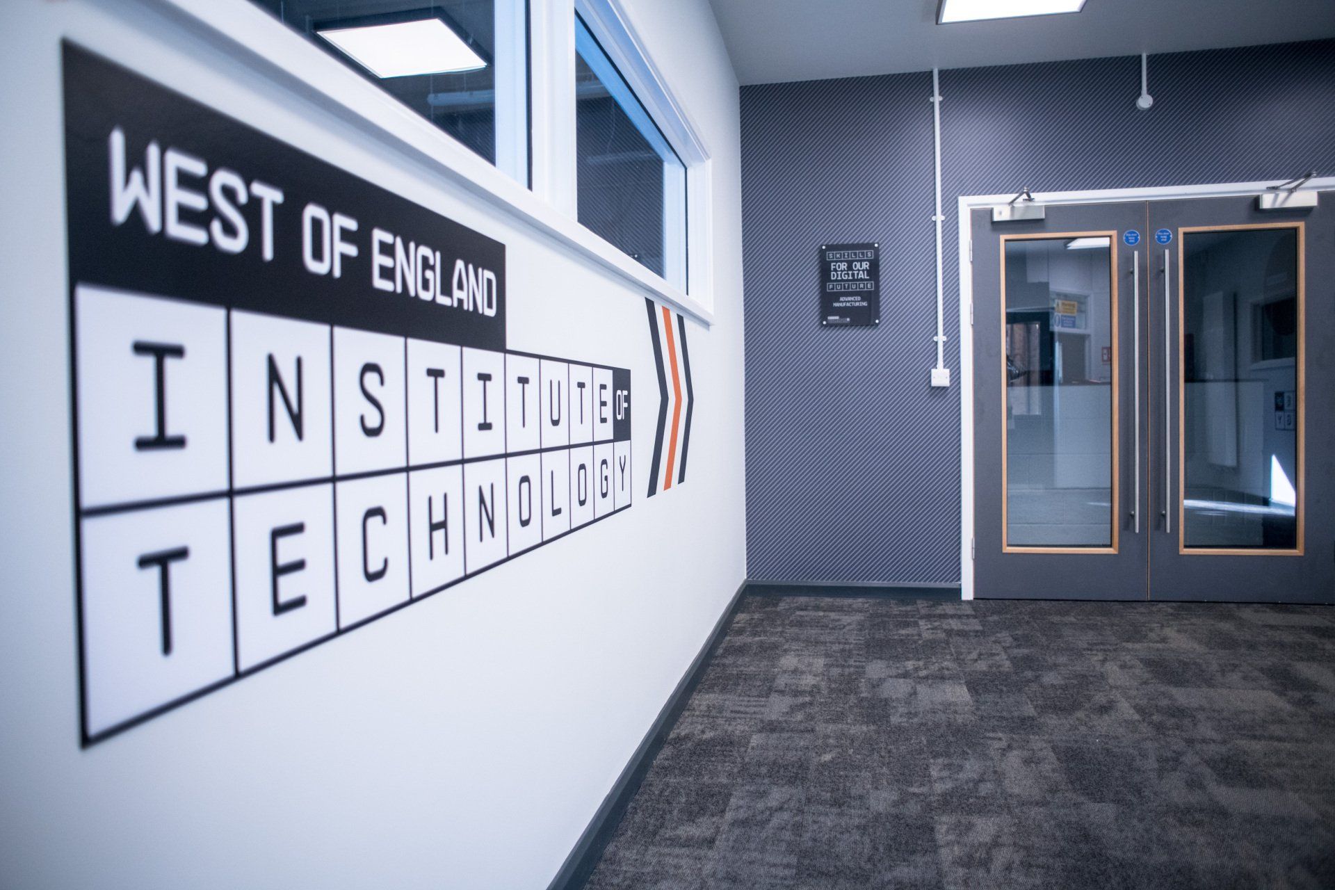 A hallway with a sign on the wall that says west of england institute of technology