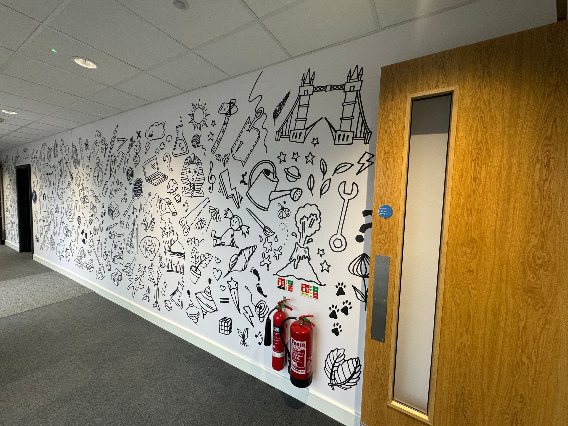 A hallway with a fire extinguisher on the wall