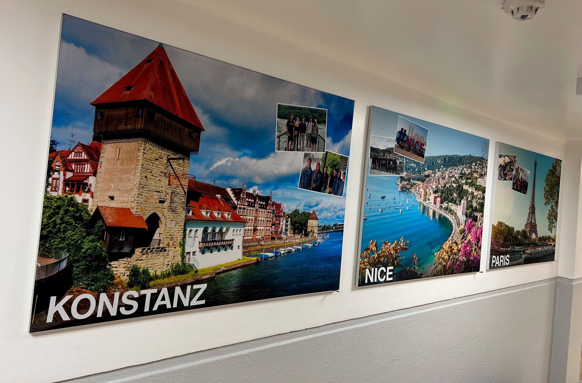 A row of posters on a wall with one that says konstanz