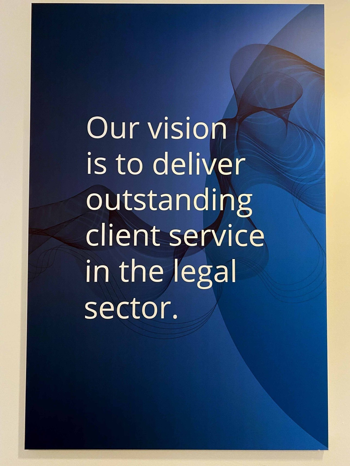 A poster that says our vision is to deliver outstanding client service in the legal sector