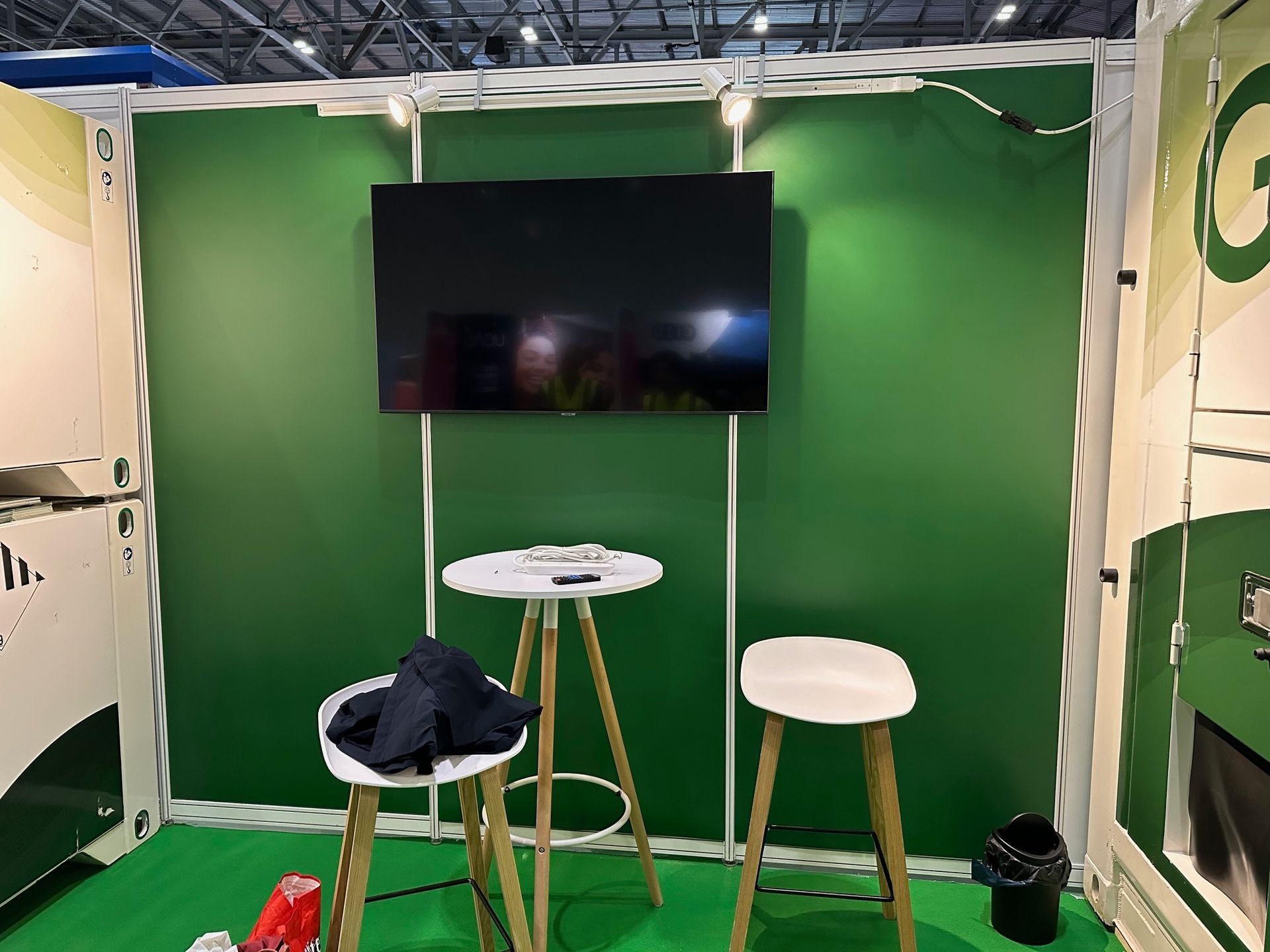 N3 Display Graphics | A green room with two tables and a television on the wall.