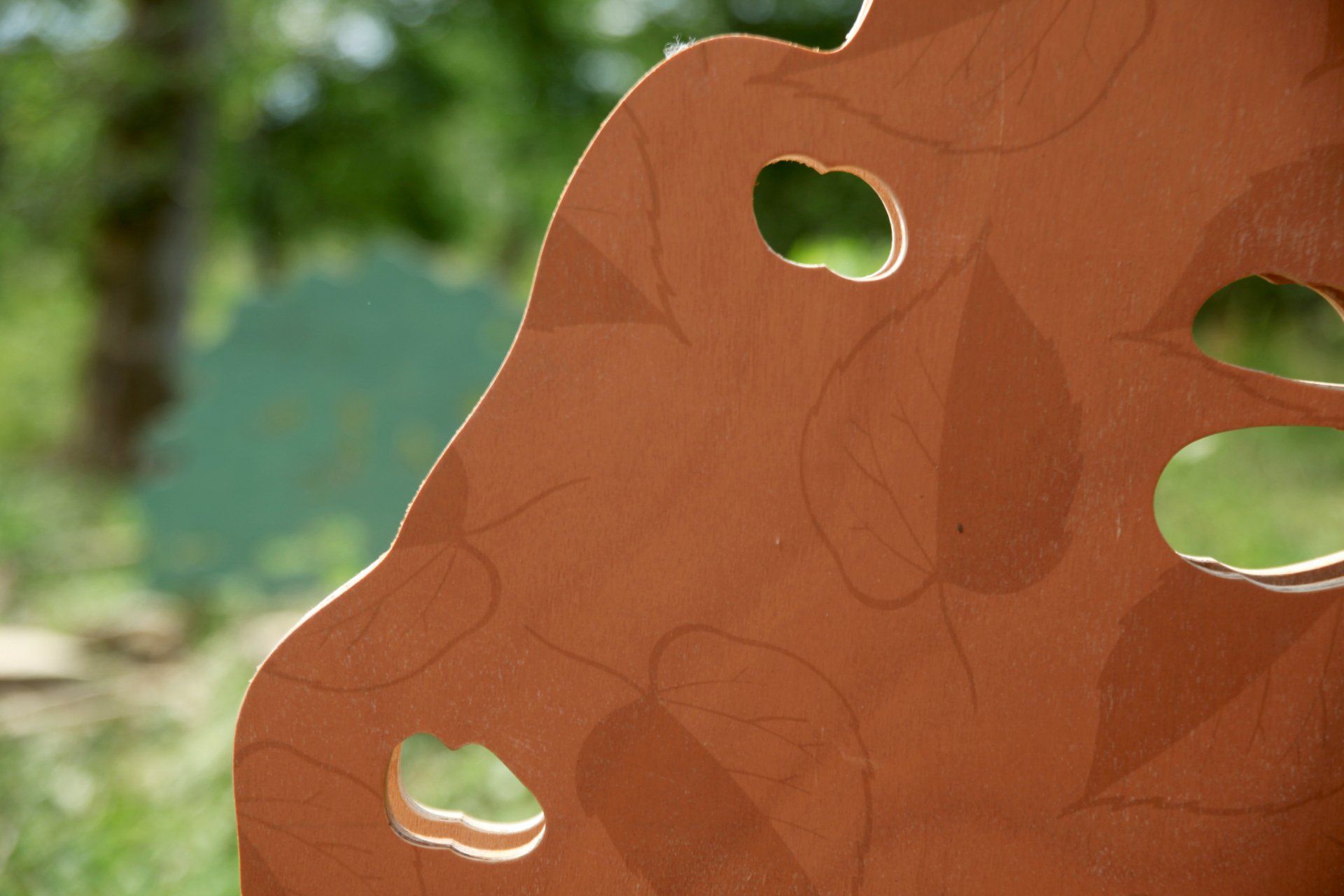 A close up of a piece of wood with holes in it