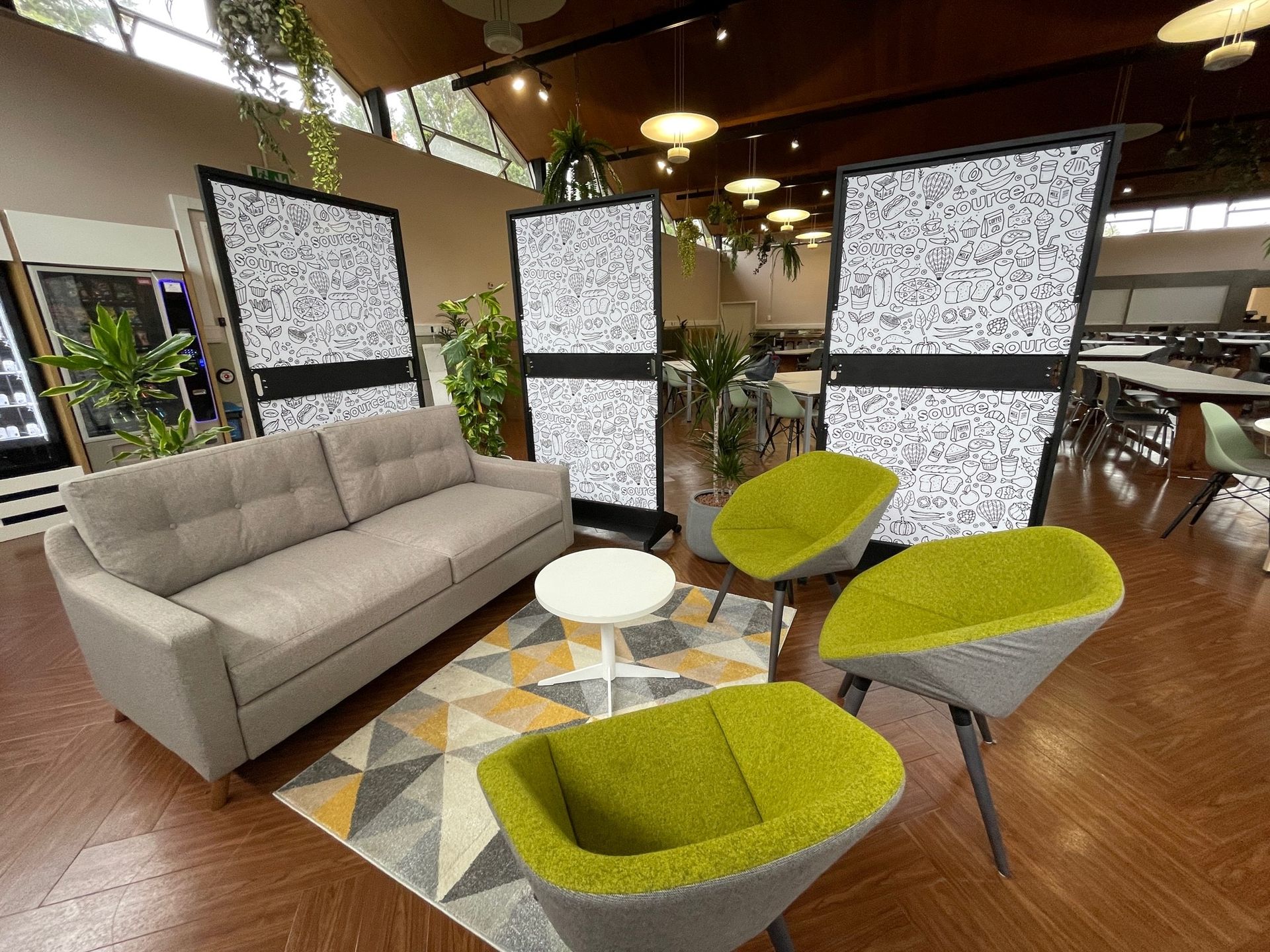 A living room with a couch , chairs , and a table.