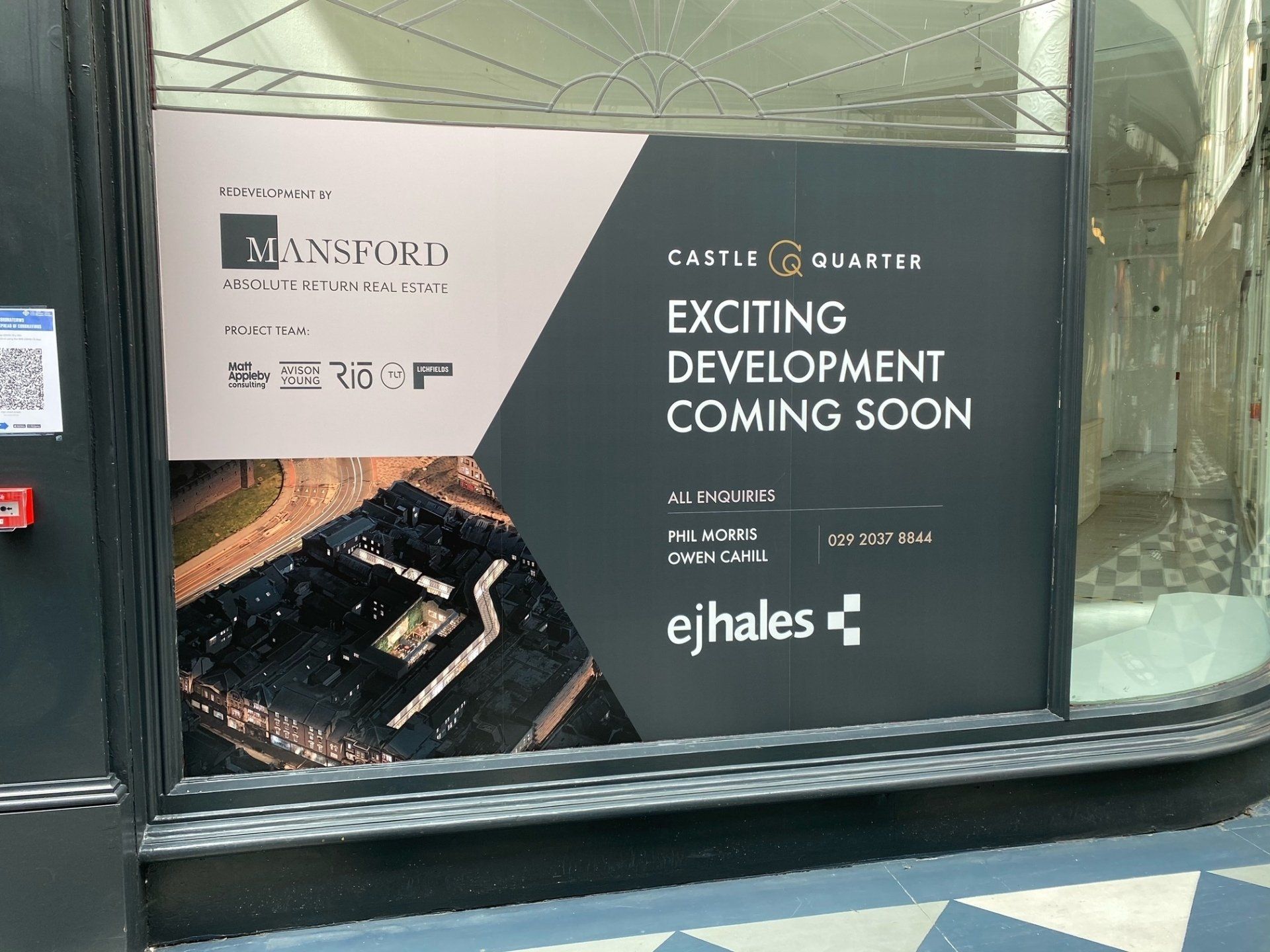A sign in a window that says exciting development coming soon